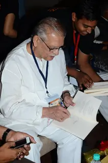 Gulzar was snapped signing autograph at the Launch of Gulzar Pluto Poems Book