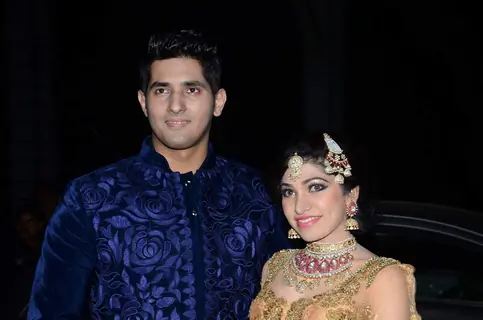 Tulsi Kumar and Hitesh Rahlan pose for the media at their Wedding Reception