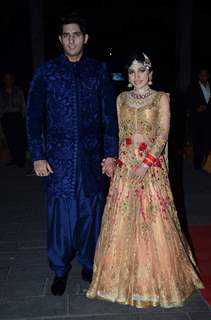 Tulsi Kumar and Hitesh Rahlan pose for the media at their Wedding Reception