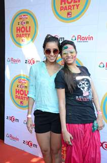 Sargun Mehta and Asha Negi pose for the media at Zoom Holi Bash