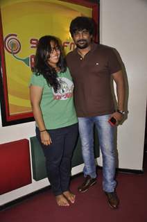 R. Madhavan poses with RJ Prerna at Radio Mirchi Studio