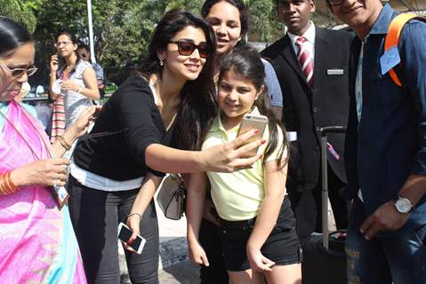 Shriya Saran was snapped clicking a selfie with a fan at Airport