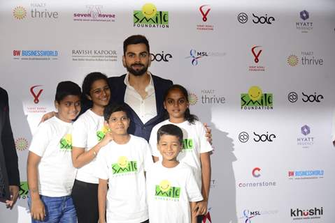 Virat Kohli poses with kids at a Charity Auction