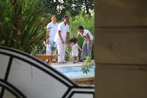 Taimur Ali Khan walking by the poolside