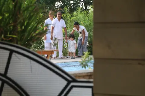 Taimur Ali Khan walking by the poolside