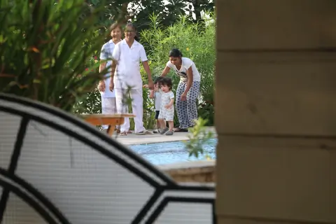 Taimur Ali Khan walking by the poolside