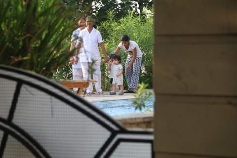 Taimur Ali Khan walking by the poolside