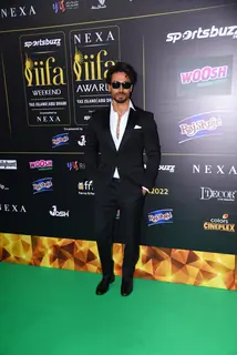 Tiger Shroff poses to paparazzi at green carpet of IIFA awards 2022 in Abu Dhabi