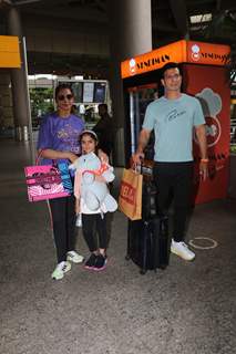 Isha Koppikar poses with husband Timmy Narang and daughter Rianna Narang snapped at the Mumbai airport 