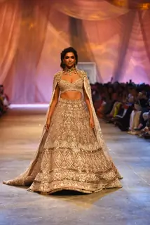 Deepika Padukone looked like a million bucks as she walked the ramp for Manish Malhotra in an ivory, embroidered lehenga