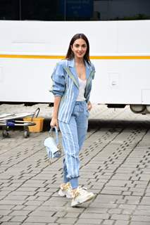 Kiara Advani sports a unique and chic fashion statement at the airport today in a denim jacket and denim track pants. She rounded up her look with a Christian Dior bag and classy shoes.