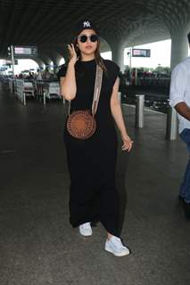 Parineeti Chopra looked gorgeous at the airport in a black bodycon gown paired with a sling bag and acap
