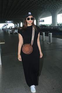 Parineeti Chopra looked gorgeous at the airport in a black bodycon gown paired with a sling bag and acap