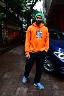 Siddhant Chaturvedi spotted in a city in an orange hoodie and a green beanie