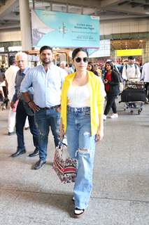 Nushrratt Bharuccha kept it casual at the airport in a yellow shirt, white top and ripped denims