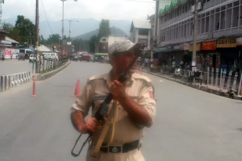 An armed security force personnel near the site of the gun fight with two militants in Srinagar