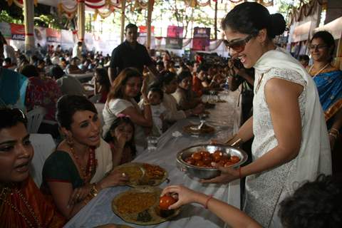 Kajol serves food to Rani Mukherjee at a Durga Pooja pandal in Mumbai