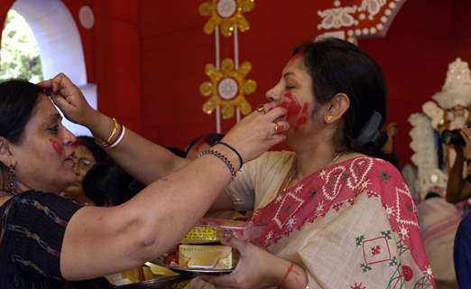 Ladies applying Vermilon after the end of Dasami at a puja pandal in East Delhi on Monday 28th September 2009 (Photo: Partha Sarkar, IANS)