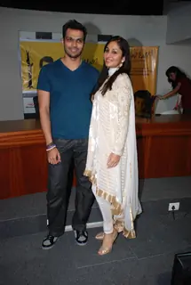 Designer Swapnil Shinde with Femina Miss India Pooja Chopra pose for the photographers after she presents a cheque of Rs 12 Lacs to Nanhi Kali, a project managed by the KC Mahindra Education Trust and the Naandi Foundation to endorse the cause