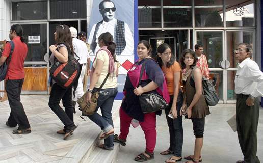 Girls stand in a queue to show the screening of a film on 15th Kolkta Film Festival at Nandan on Wednesday