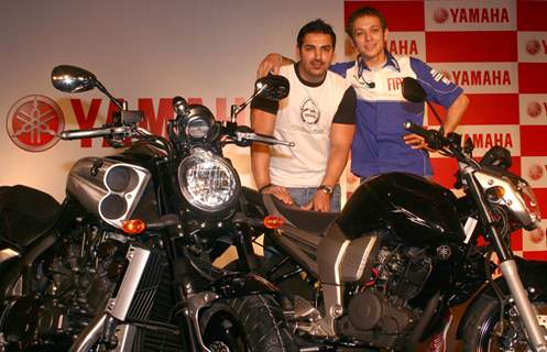 Motogp world champion Valentino Rossi and Bollywood actor John Abraham at a press meet in New Delhi on Sunday