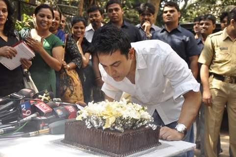 Aamir Khan blows his 45rd birthday candles as he celebrates his 45rd birthday with media today at his home in Mumbai