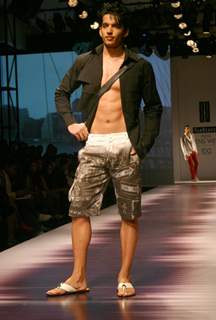 A model showcasing designers Karan Johar and Varun Bahl''s creations at the Ven Heusen India Mens Week, in New Delhi