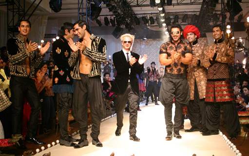 Designer Rohit Bal with Bollywood actor John Abraham  during his show  at the Ven Heusen India Mens Week, in New Delhi