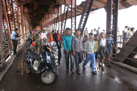 People watching overflowing Yamuna River at old bridge in  Delhi on Saturday