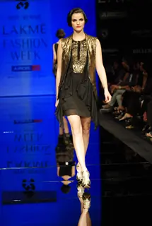 A model walks the runway in an Ritu Kumar design at the Lakme Fashion Week