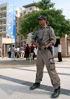 A security person  at the Commonwealth Games village in New Delhi on Saturday-IANS Photo by Amlan Paliwal