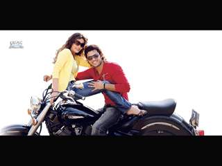 Kumar Saahil and Sneha Ullal sitting on a bike