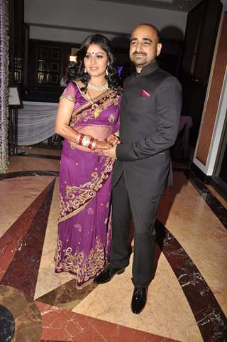 Singer Sunidhi Chauhan poses with her husband musician Hitesh Sonik at her wedding reception