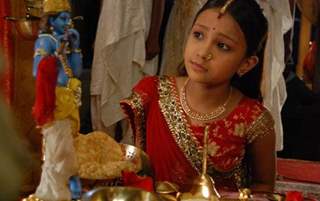 Meera talking to Krishna idol