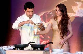 Chef Kunal Kapur prepares a dish for Soha Ali Khan at Magnum Promotional Event