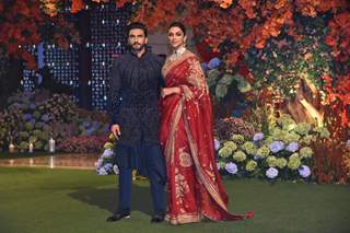 Deepika Padukone looked ethereal in a red saree, embroidered blouse and a choker set while Ranveer Singh wore a navy blue jacket, paired with matching kurta and trousers.