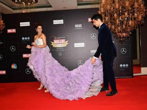 Sidharth Malhotra helping Kriti Sanon with her gown