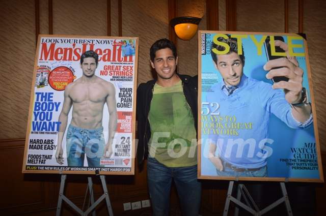 Sidharth Malhotra poses alongsidethe cover of Men's Health and Style Media