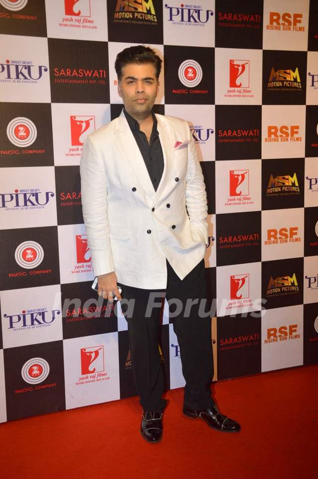 Karan Johar poses for the media at the Success Bash of Piku