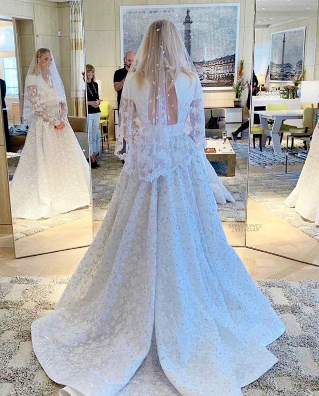 Sophie Turner Wears a White Wedding Dress Featuring a Long Veil