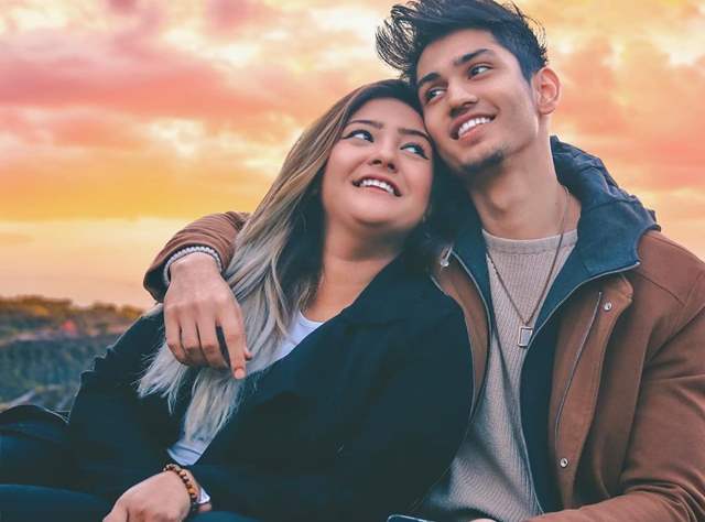 Beloved young Asian Woman embracing back of boyfriend taking selfie on  smartphone during romantic date in park Stock Photo - Alamy