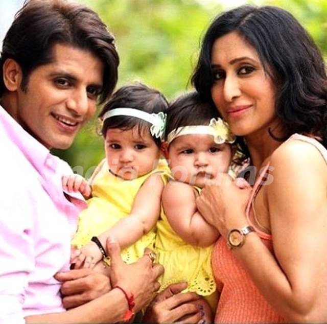Teejay Sidhu with her husband and  twin daughters