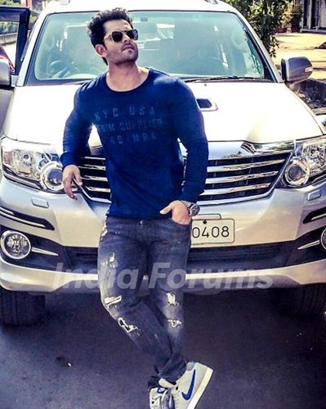 Shoaib Ibrahim poses with his Toyota Fortuner car