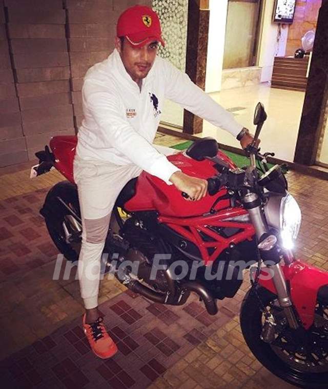 Gaurav S Bajaj poses with his Ducati Monster bike