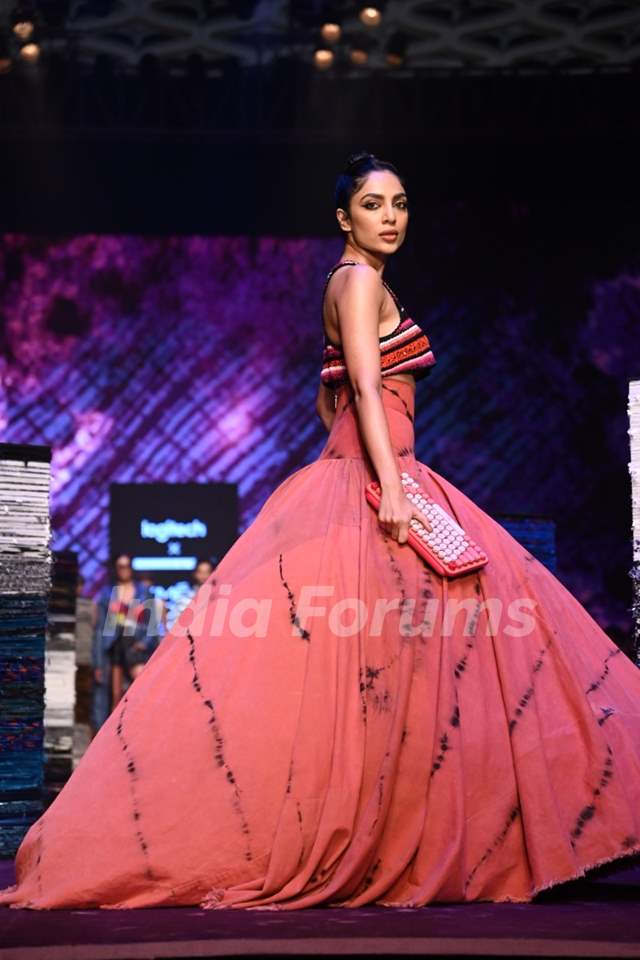 A model walks the ramp in a jazzy gown.