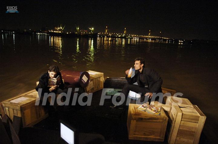 Neil and Rahul sitting on a beach