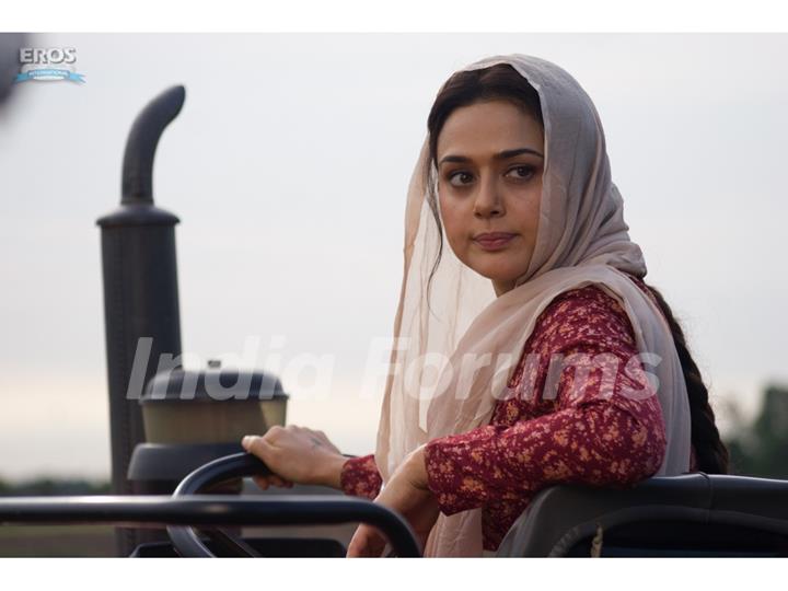 Preity Zinta  sitting on a tractor