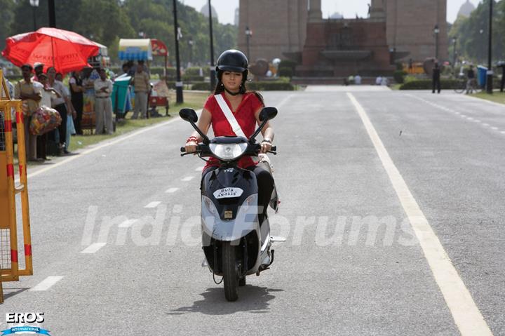 Ayesha Takia riding a scooty