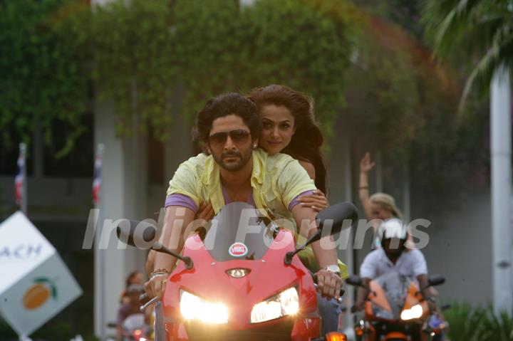 Arshad Warsi and Amrita Arora sitting on a bike