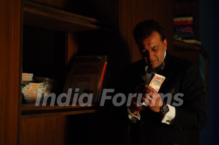 Sanjay Dutt with a bundle of Rupees